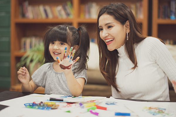 Mother and daughter finger painting